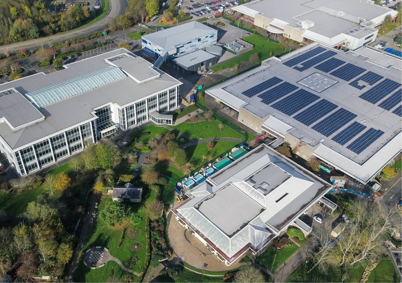 Aerial view of industrial campus with solar panels.