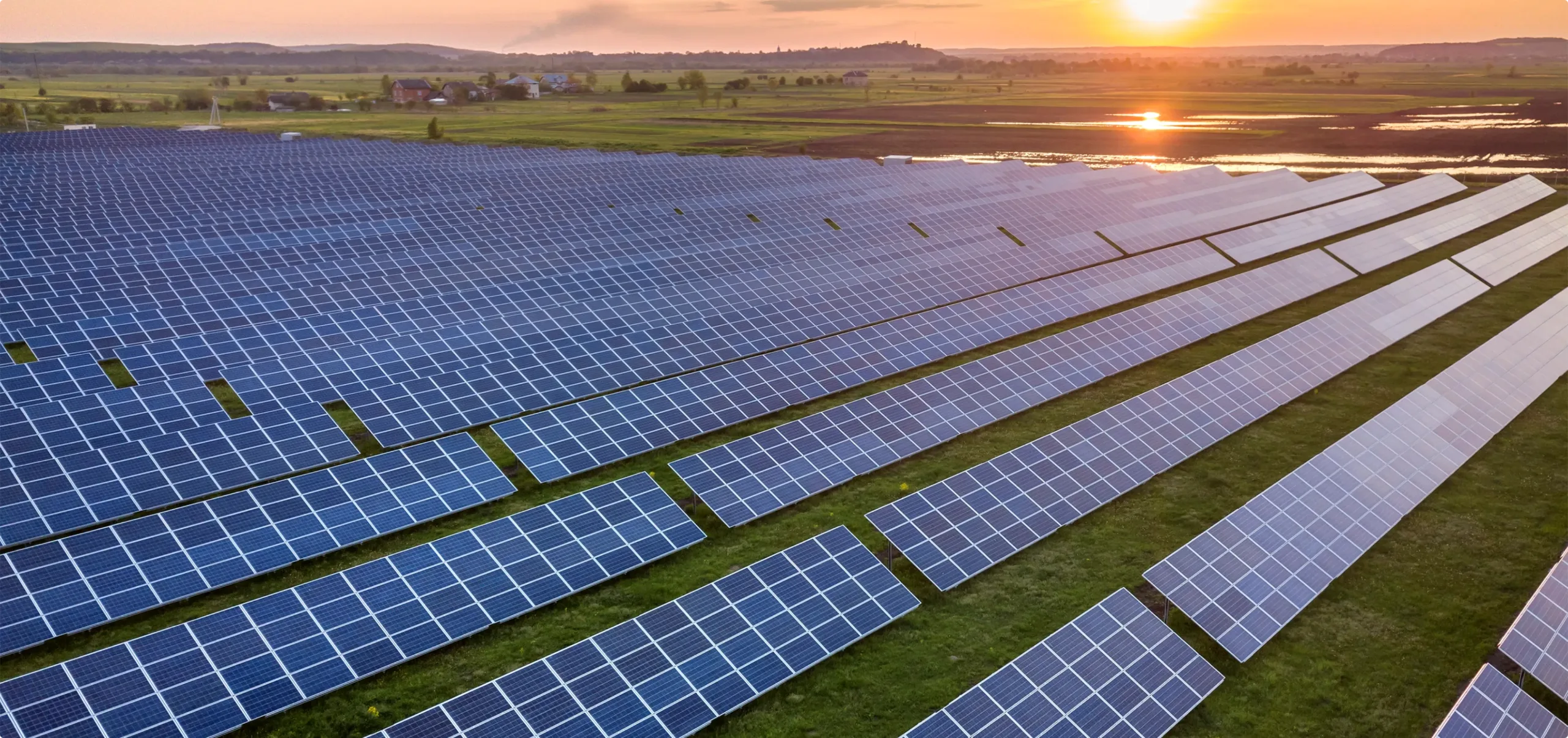Vast solar panels at sunset, renewable energy landscape.